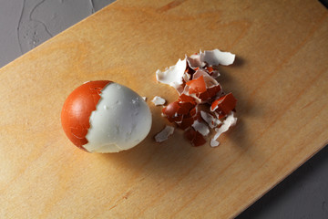 fried chicken egg and eggshell on a cutting board