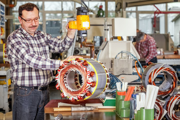 Skilled industrial worker assembling a large electric motor