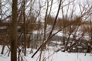Small river with a small waterfall in winter
