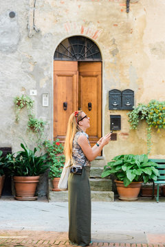 Fototapeta Young female traveler on the streets of an old town in Tuscany Italy