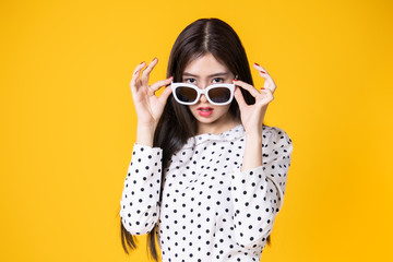 Asian woman in summer casual clothes.She smiling and  happy shopping. she  lovely attractive shine on  yellow background.Summer Surprise Sale  concept. - obrazy, fototapety, plakaty