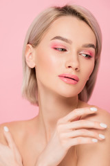 attractive tender woman with pink makeup, isolated on pink