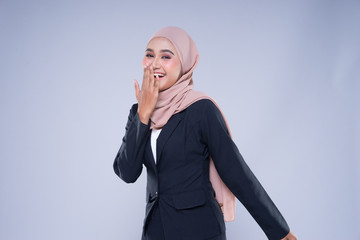 Half length portrait of an attractive Muslim businesswoman wearing hijab with mixed poses and gestures isolated on grey background. For image cutout for corporate, technology, business or finance.