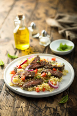 Beef steak salad with pasta and vegetables