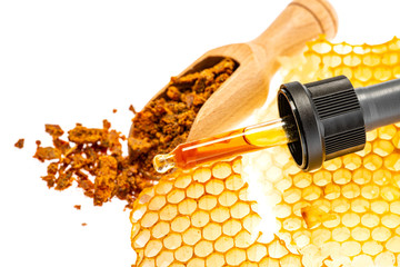 propolis tincture and a wooden spoon of propolis granules