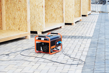 Mobile backup generator on the construction site. Standby generator - outdoor power equipment.