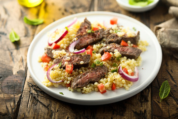 Beef steak salad with pasta and vegetables