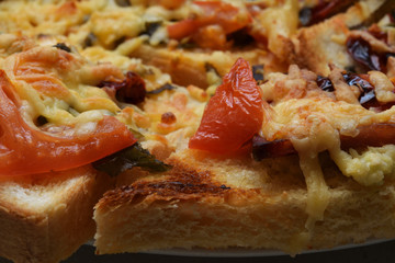 Tomato slices on baked croutons with cheese