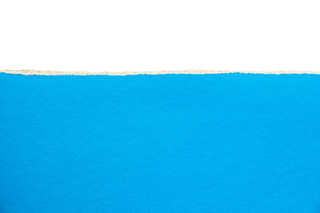 Bright blue torn piece of cardboard paper on white background. Copy space for text message.