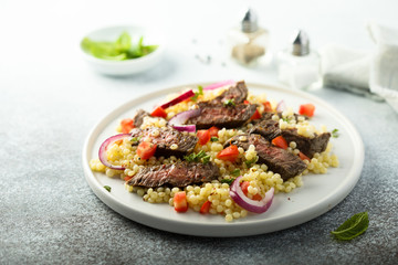 Beef steak salad with pasta and vegetables