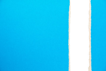 Blue ripped pieces of cardboard paper on white background. Copy space for text message.