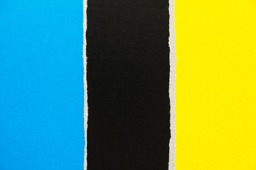 Black, blue and yellow torn cardboard paper texture background. Copy space for text message.