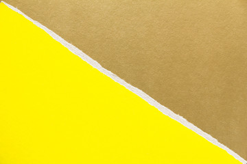 Yellow and golden brown torn sheet of cardboard paper with diagonal border texture background. Can...