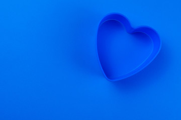  Blue heart shape on blue background. Copy space.