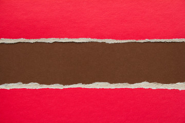 Red and brown torn and ripped sheet of cardboard paper texture background. Can be used for text...