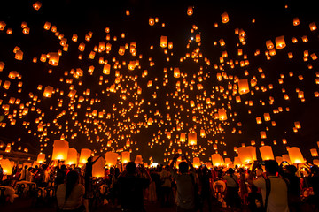 Lanna Dhutanka, Chiang Mai, Thailand - November 11, 2019: People floating lanterns to the sky in...