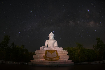 Photograph of milky way rising over big buddha on the hill in Thailand.