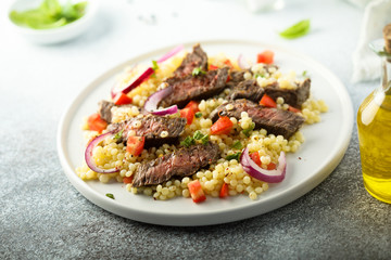 Beef steak salad with pasta and vegetables