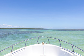 Top view of a yacht boat from natural pools in blue sea in Morro de Sao Paulo, Bahia, Brazil.