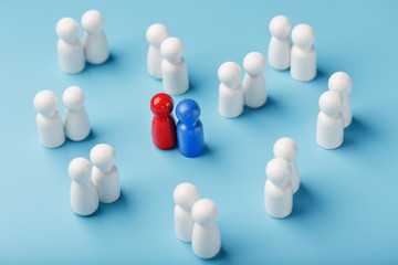 Choosing a sexual partner for love, relationships from such a crowd of monotonous people. A red woman and a blue man in a crowd of white people.