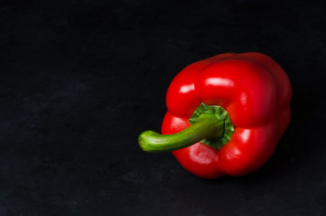 Red pepper on a black background. Paprika. The species capsicum annuum. Copy space