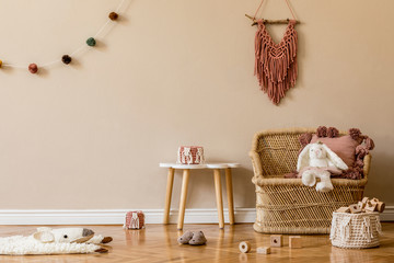 Stylish and cute scandinavian decor of newborn baby room with natural toys, hanging decor balls,...