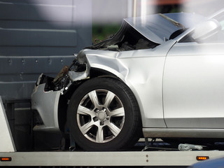 Car transportation after an accident on a tow truck. Vehicle after a frontal collision