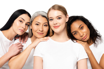 cheerful multicultural women in white t-shirts looking at camera isolated on white