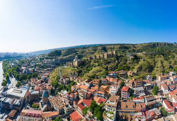 Panorama of the old town on Sololaki hill, crowned with Narikala fortress, the Kura river and cars traffic with blure in Tbilisi, Georgia.