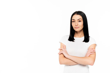 attractive woman standing with crossed arms isolated on white