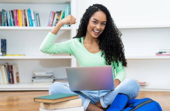 Successful latin american female student with retainer and computer