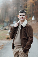 Teen guy. Happy stylish boy posing. Portrait of handsome young male outdoors. Fashionable guy. Young boy portrait outdoors. Happy young guy posing outdoor.