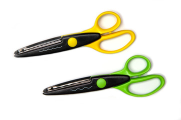 Yellow and green crafted zigzag scissors for art and craft work  isolated on white background