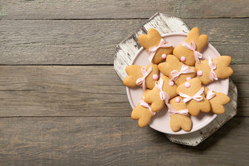 Easter cookies on a plate on an old wooden background. Top view. Place for text.