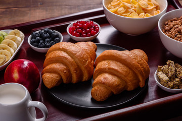 Delicious breakfast with fresh croissants and ripe berries