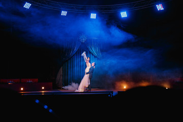 a couple of newlyweds posing on the circus stage. Theater Stage Wedding