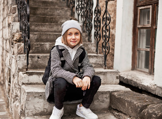 10 years old girl walks on the street dressed in comfortable clothes