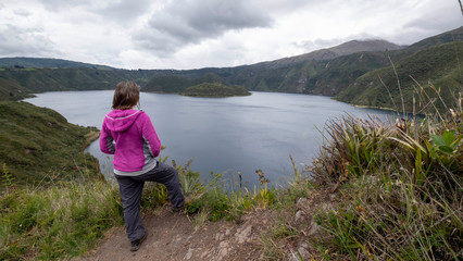 Naklejka premium Viewpoint with girl overlooking the Cuicocha lagoon in Ecuador