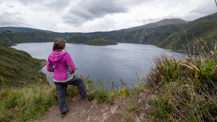 Viewpoint with girl overlooking the Cuicocha lagoon in Ecuador