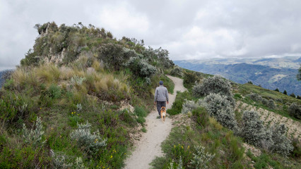 Hiker on trail around the Quilotoa lagoon in Ecuador