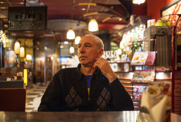 man in a cafe in the evening