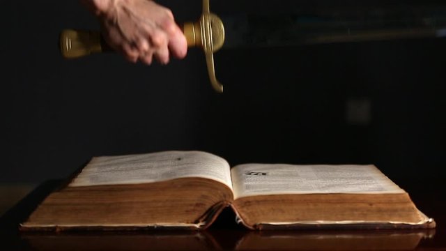Young Man Picks Up Sword Near Bible