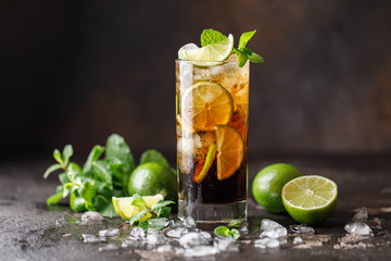 Cuba Libre with brown rum, cola, mint and lime. Cuba Libre or long island iced tea cocktail with strong drinks