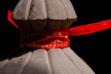 Chongqing, China - March 21, 2018: Red ribbon with mantras, prayers on the railing in a Buddhist...