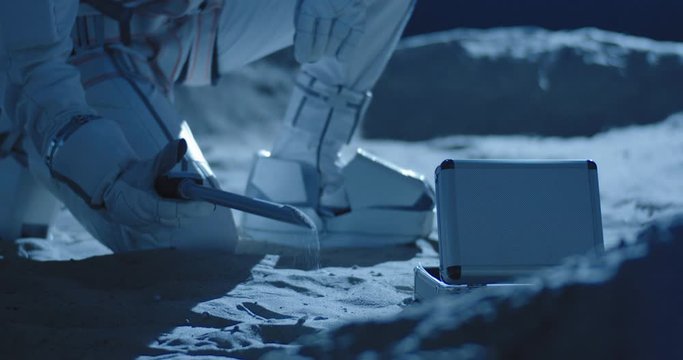 Astronaut using equipment to collect samples
