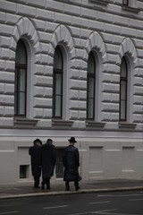 Three jewish men walking in the street