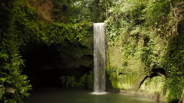 Aerial drone flight over magic Air Terjun Tibumana waterfall, Bali, Indonesia, 4k
