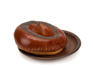 Fresh homemade Poppy bagel bread in a plate on a white background