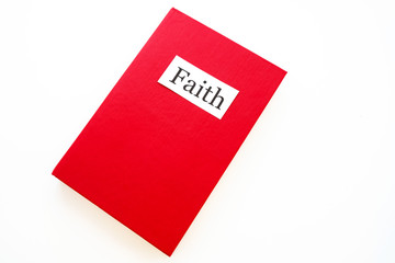 a book about faith in red on a white background