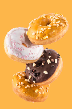 Flying Donut or Doughnut Creative Image. Falling Food On White Background. Food in Motion